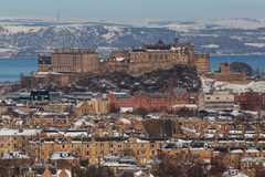 Edinburgh Castle and the snowy hills of Fife in distance
